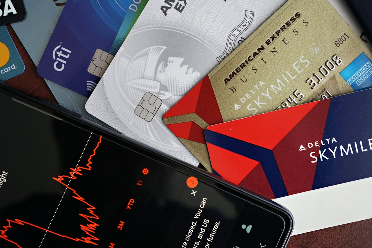 Image showing credit cards and a financial market graph on a smartphone.